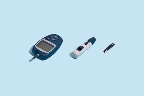 Glucose meter and pen on blue background with shadow, Metabolic syndrome concept