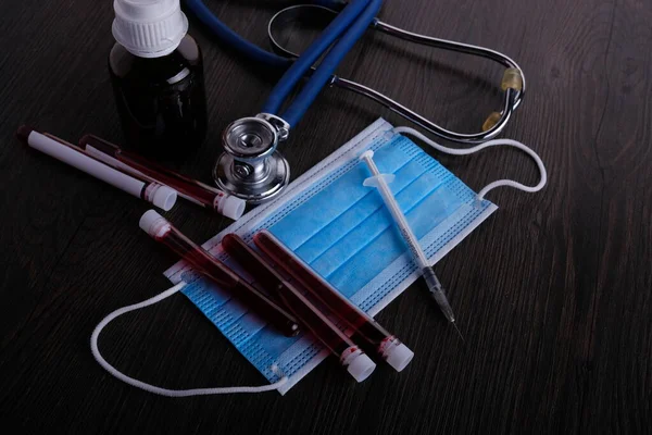 Medical or medicine with doctor tool. Stethoscope, syringe, blood on table