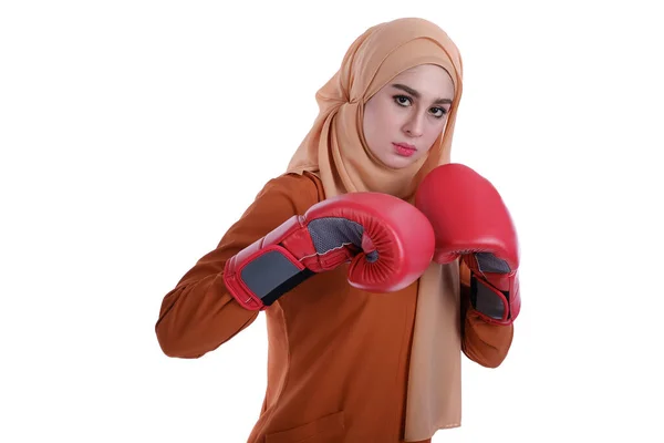 Pretty muslim woman using boxing glove with expression face style.