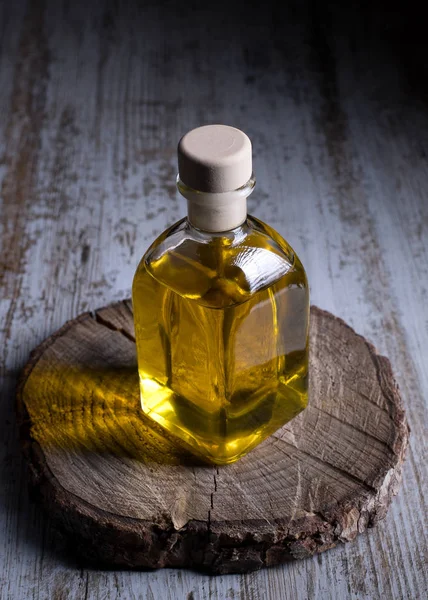 Bottle with olive oil inside, insulated on rustic wooden backgro — Stock Photo, Image