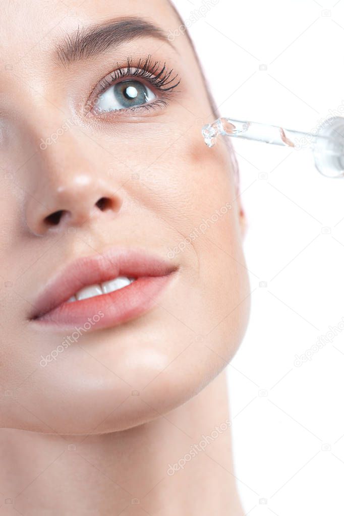 Young beautiful woman with pipette with clean perfect skin closeup. Beauty portrait