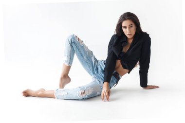 Siyah gömlekli ve beyaz arka planda mavi muz kotlu havalı genç kız. Modaya uygun modern tarz.