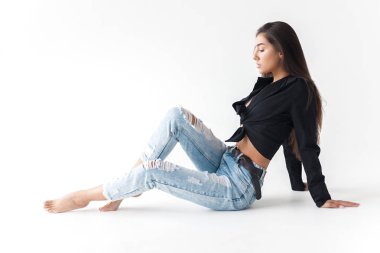 Siyah gömlekli ve beyaz arka planda mavi muz kotlu havalı genç kız. Modaya uygun modern tarz.