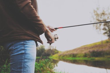 Genç balıkçı iplik ile Nehri'nde balık tutuyor. Hobi ve açık hava etkinlikleri kavramı