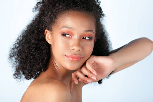Young beautiful black girl with clean perfect skin close-up. Beauty portrait