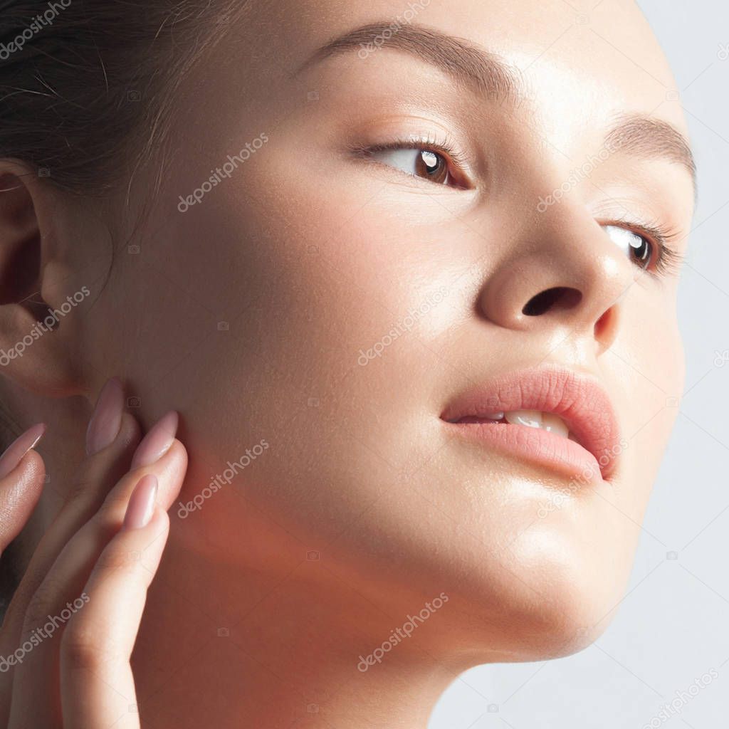 Young beautiful woman with clean perfect skin close-up. Beauty portrait