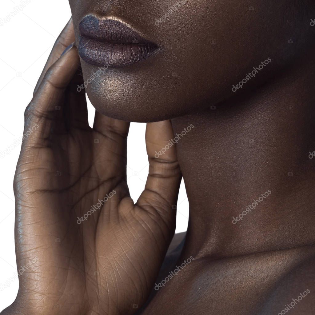 Palm and lips of young beautiful black woman with clean perfect skin close-up. Skin care and beauty concept