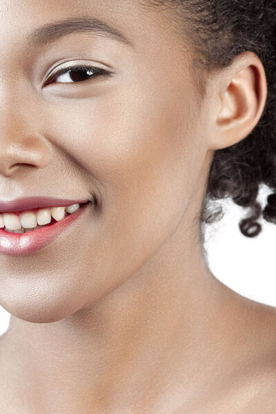Young beautiful girl with clean perfect skin smiles close-up. Beauty portrait