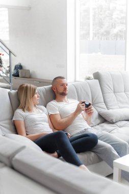 Genç bir çift oyun Tv konsol. Aile hafta sonu dinlenmek ev kanepe