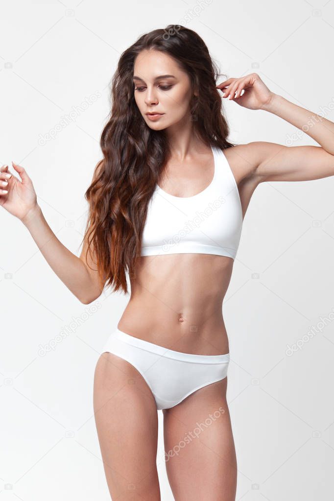 Sexy young woman in underwear on white background. Beauty portrait. Skin and body care