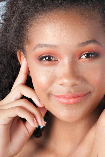 Young beautiful black girl with clean perfect skin close-up. Beauty portrait