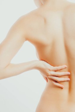 Çıplak ince kadın sırtına dokunuyor. Omurga ağrısı, böbrek iltihabı, osteokondrosis.
