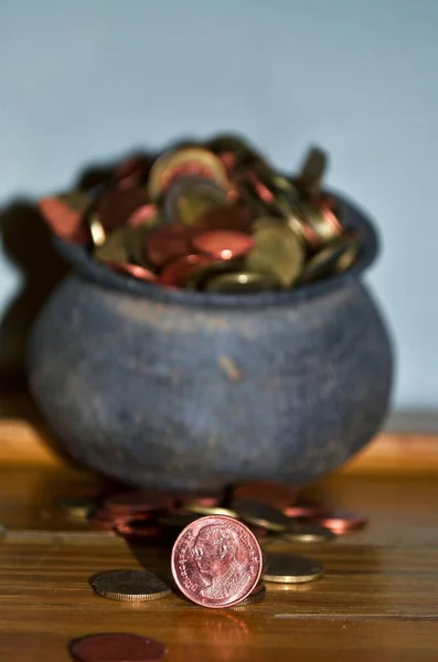 The Coins from around the world in the old black pottery isolated for collecting, business concept , Save money concept