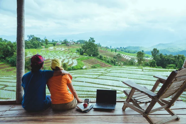 Lover woman and man Asian travel nature. Travel relax. The balcony of the resort. View of the field on the Moutain. summer, laptop, computer, ducation, read a book, book, Write a note, diary, nature, outdoor, holiday, sport, relax, travel Thailand.