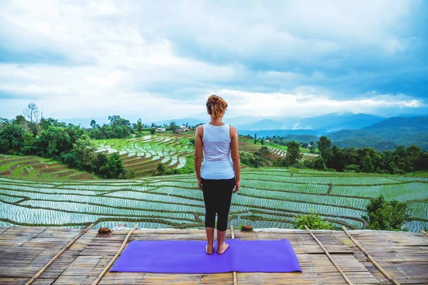 Ázsiai nő pihenni a nyaralni. Játszani, ha jóga. Az erkélyen táj természetes mező. gyakorlása, jóga, nyár, vidék, sport, Relax, utazás, természet, szabadtéri, nyaralás, utazás Thaiföld. — Stock Fotó