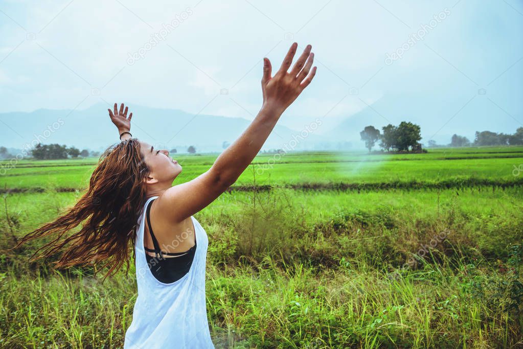 Asian women travel relax in the holiday. Stand in a meadow 