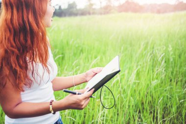 Kadınlar notlar yazar. Doğa yolları, dağlar, ormanlar. Yazar. Asi