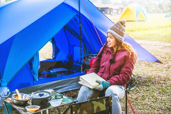 Le donne asiatiche viaggiano rilassarsi campeggio in vacanza. campeggio sulla Montagna. sedersi rilassarsi leggere un libro sulla sedia. Tailandia — Foto Stock