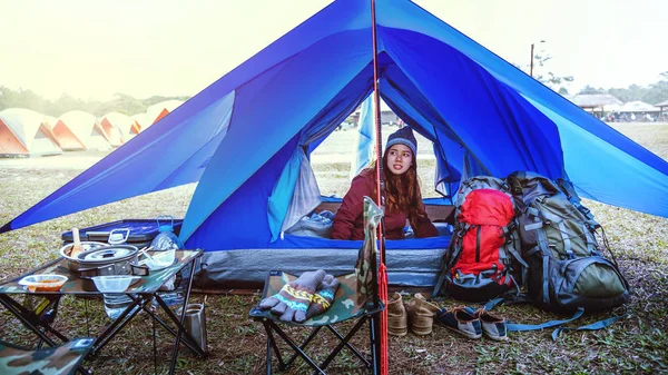 Asian women travel relax in the holiday. The young woman travels nature. Travel relax. Tourist overnight camp on the mountain. camping tent, camping Thailand. women travel countryside.  travel Thailand. adventure, outdoor, holiday, relax.