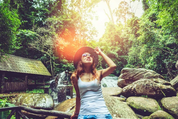Asian women travel relax in the holiday. mountains, waterfalls. mountain, countryside, forest, nature, outdoor, holiday, relax, travel, summer, travel Thailand.