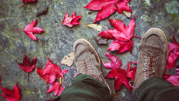 Male foot asians travel relax in the holiday.Standing on a maple