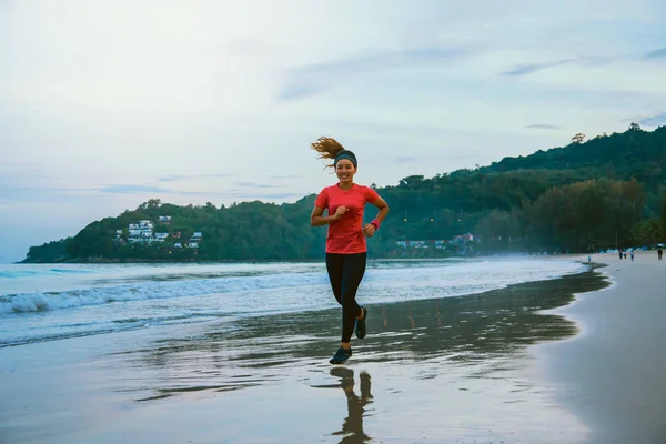 Woman jogging workout on the beach in the morning. Relax with the sea walk. Jogging on the beach, for health, good health, exercise.