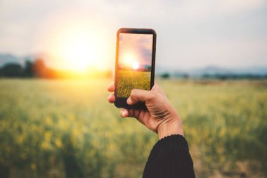 Cep telefonu fotoğrafını kullanan kadın eli. Dağ doğası