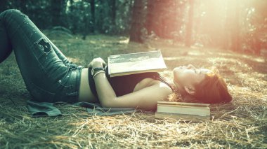Woman relaxing reading in park. holiday Sleep rest in reading. Young women relax, sleep, read books during the holidays. nature, outdoor, holiday, education, read a book, book, Write a note, diary. clipart