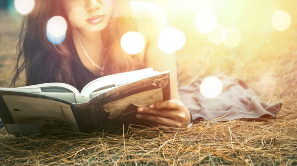 Woman relaxing reading in park. holiday Sleep rest in reading. Young women relax, sleep, read books during the holidays. nature, outdoor, holiday, education, read a book, book, Write a note, diary, blurred photo.