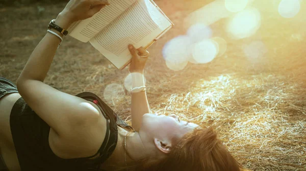 Woman relaxing reading in park. holiday Sleep rest in reading. Young women relax, sleep, read books during the holidays. nature, outdoor, holiday, education, read a book, book, Write a note, diary.