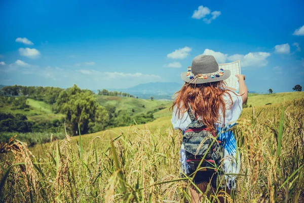 Asian women travel relax in the holiday. Expand survey map Mountain field. crop rices Ranch on hill. Thailand