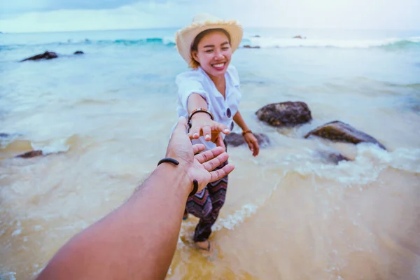 Asian lovers couple happy travel nature on the beach. Couple running on a sandy beach.Travel relax in summer