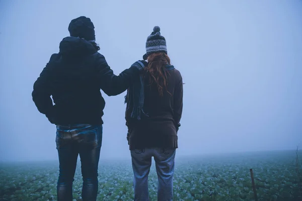 Lover women and men Asians travel relax in the holiday. Happy to travel in the holiday. Lovers walk hand in hand on rice field. During the foggy winter — Stock Photo, Image