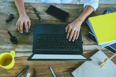 ahşap masada oturan kadınlar bir defterle çalışıyor ve evde kahve içiyorlar. tatilde