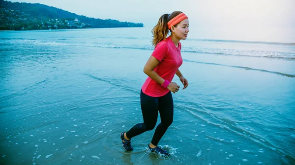 Allenamento di jogging femminile sulla spiaggia al mattino. Rilassati con la passeggiata sul mare. in estate — Foto Stock