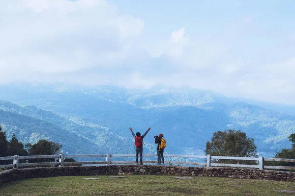 Couples traveling photography nature at sheep farm at Doi Pha Tang, Doi Inthanon National Park, Chom Thong, Chiang Mai, Thailand