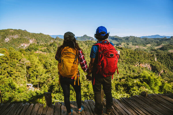 Travel, nature travel of Asian couples while is relaxing outdoors during his trip in Thailand.