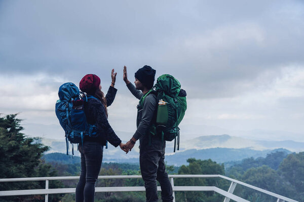Asian couples travel nature on the mountains in winter.Travel relax. Natural touch countryside at doi inthanon in Thailand.