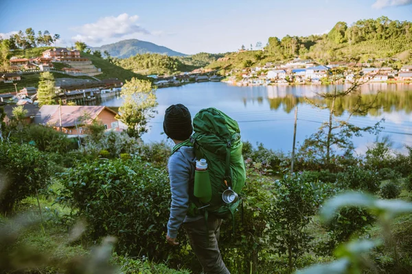 Hombre asiático viajar naturaleza. Viaje relajarse, Camping en un pueblo rural en la montaña, cerca del lago . — Foto de Stock