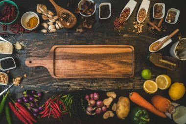 Ahşap zemin üzerinde pişirme malzemesi olarak kullanılacak baharatlar ve taze organik sebzeler. Sağlıklı bitkiler ve baharatlar. Köy tahtasında organik sebzeler.