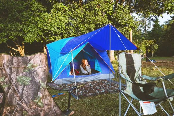 travel relax in the holiday. camping on the Mountain. Young woman tourists camping relax On the Mountain in the jungle. Travel nature. camping tent