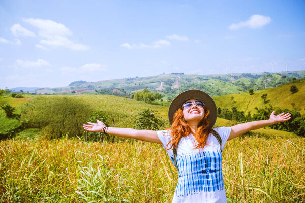 Asian women travel Rice fields green On the mountains in the holiday. happy and enjoying a beautiful nature. Rice fields Golden. summer