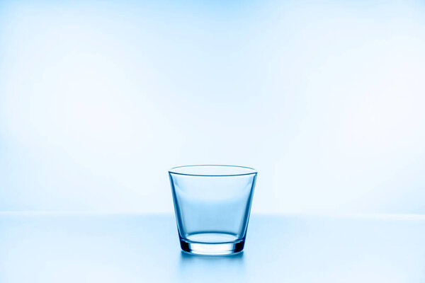water splashing from glass isolated on blue background
