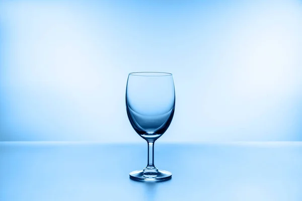 water splashing from glass isolated on blue background