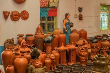 A variety of local handmade Clay pottery and home decor sold in Goa India  clipart