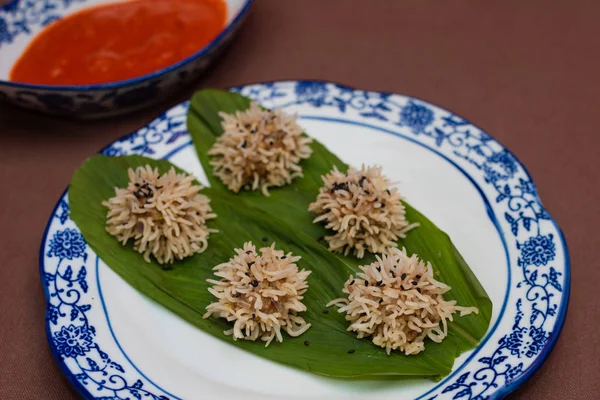 Chicken flower dumplings- Chicken mince balls covered with soaked rice and steamed and served with red chilly sauce