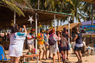 Agonda Beach, Goa/India- March 2 2018: Tourists  enjoying the surf and sand at Agonda Beach in Goa, India clipart