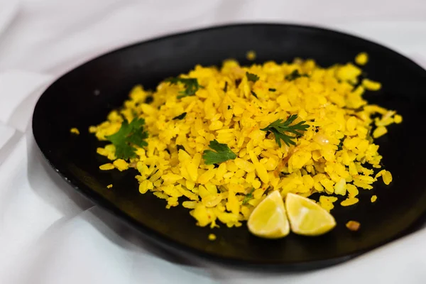 Traditional western Indian breakfast using rice flakes (flattened rice) called Aloo Pohe