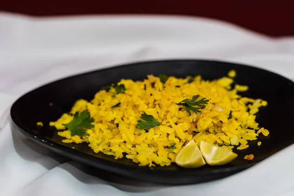 Traditional western Indian breakfast using rice flakes (flattened rice) called Aloo Pohe