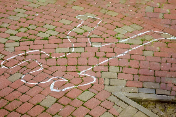 Crime scene with human body outline by chalk,drawing on the pavement. Outdoors, copy space..